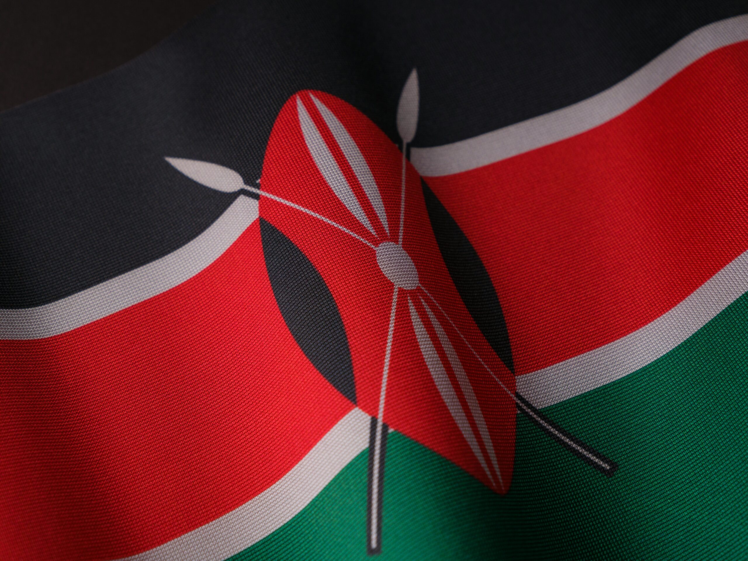 Detailed close-up of the vibrant Kenyan flag waving with texture visible.
