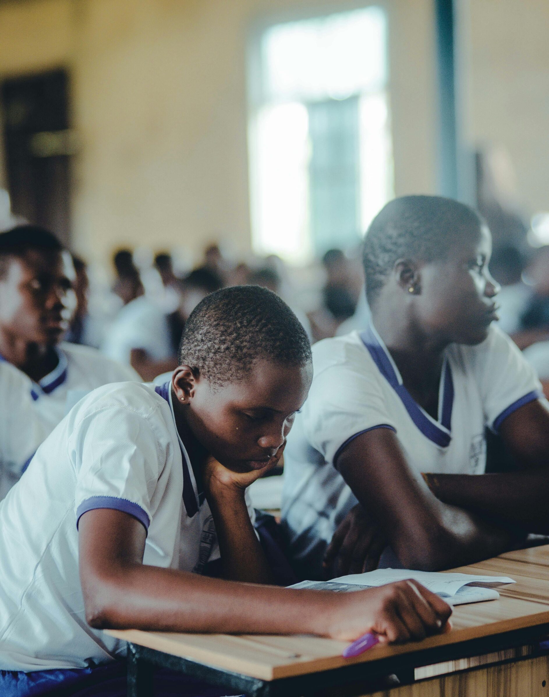 Students engaged in focused classroom study, highlighting educational dedication.