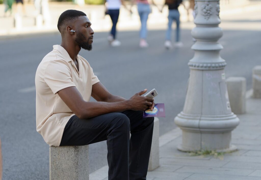 man, smartphone, earbuds, african, casual, relaxing, sitting, stone, street, urban